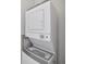 Convenient, stacked washer and dryer unit in a dedicated laundry space at 956 Sombra St, Tampa, FL 33619