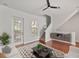 Bright living room with hardwood floors, stylish furniture, a modern ceiling fan, and natural light from the doors at 956 Sombra St, Tampa, FL 33619
