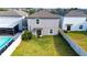 Aerial view of a fenced backyard with a sparkling pool and lush green grass at 9617 Channing Hill Dr Dr, Ruskin, FL 33573