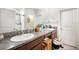 Double sink bathroom vanity with a large mirror and a door to the shower/toilet at 9617 Channing Hill Dr Dr, Ruskin, FL 33573