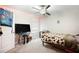 A bedroom featuring carpeted floors, a window, a bed, and a ceiling fan at 9617 Channing Hill Dr Dr, Ruskin, FL 33573