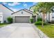 Charming home with a two-car garage, well-maintained landscaping and a gray facade at 9617 Channing Hill Dr Dr, Ruskin, FL 33573
