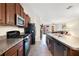 Functional kitchen with wood cabinets, granite countertops, and a view to the living area at 9617 Channing Hill Dr Dr, Ruskin, FL 33573