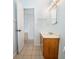 Bathroom featuring tile flooring, a wooden vanity, and a well lit mirror, with blue accents at 1021 Apollo Beach Blvd # 6, Apollo Beach, FL 33572