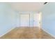 This spacious bedroom features tile flooring, a closet, and fresh light blue paint at 1021 Apollo Beach Blvd # 6, Apollo Beach, FL 33572