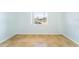 A sunlit bedroom features tile flooring, a window overlooking the neighborhood, and fresh light blue paint at 1021 Apollo Beach Blvd # 6, Apollo Beach, FL 33572