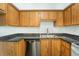 Well-equipped kitchen showcasing wood cabinetry and stainless steel dishwasher at 1021 Apollo Beach Blvd # 6, Apollo Beach, FL 33572