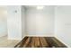 The living room features modern dark hardwood flooring and freshly painted white walls with blue accents at 1021 Apollo Beach Blvd # 6, Apollo Beach, FL 33572