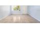 The bright living room features a large window with natural light, tile flooring, and fresh light blue paint at 1021 Apollo Beach Blvd # 6, Apollo Beach, FL 33572