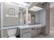 Functional bathroom featuring double sinks, ample counter space, and a large mirror at 1034 Mandarin Dr, Holiday, FL 34691