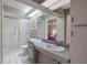 Well-lit bathroom with a walk-in shower, double sink vanity, and modern fixtures at 1034 Mandarin Dr, Holiday, FL 34691