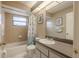 Bathroom featuring a shower and tub combination, vanity and decorative details at 1034 Mandarin Dr, Holiday, FL 34691
