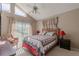 Cozy bedroom featuring a vaulted ceiling, fan, and a sliding glass door to enjoy ample natural light at 1034 Mandarin Dr, Holiday, FL 34691