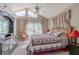 Comfortable bedroom with vaulted ceiling, ceiling fan, and a dresser for storage at 1034 Mandarin Dr, Holiday, FL 34691