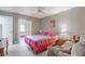 Comfortable bedroom with a seating area, a bed, and ample natural light at 1034 Mandarin Dr, Holiday, FL 34691