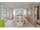 The dining room has a view of the lanai and features elegant furniture and a china cabinet at 1034 Mandarin Dr, Holiday, FL 34691