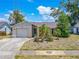 Charming single story home with well maintained landscaping and attached garage at 1034 Mandarin Dr, Holiday, FL 34691
