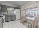 Cozy kitchen featuring grey cabinetry with a view to the outdoor living space provides a serene atmosphere at 1034 Mandarin Dr, Holiday, FL 34691