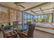 Enclosed lanai with patio furniture offers a private outdoor retreat, perfect for relaxation and entertainment at 1034 Mandarin Dr, Holiday, FL 34691