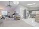Open concept living area with chandelier, ceiling fan, and view of the adjacent kitchen at 1034 Mandarin Dr, Holiday, FL 34691