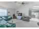Living room with a green sofa, a gray easy chair, and an open doorway to the kitchen at 1034 Mandarin Dr, Holiday, FL 34691