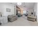 Comfortable living space with vaulted ceiling, ceiling fan, and access to the front door at 1034 Mandarin Dr, Holiday, FL 34691