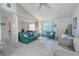 Bright living room featuring vaulted ceilings, large mirror, and comfortable seating at 1034 Mandarin Dr, Holiday, FL 34691