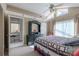 Comfortable bedroom showcasing an ensuite bathroom, vaulted ceiling, and a ceiling fan at 1034 Mandarin Dr, Holiday, FL 34691