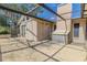 Exterior view of covered patio with access door and partial screen enclosure at 1034 Mandarin Dr, Holiday, FL 34691