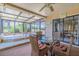 Enclosed patio with wicker furniture, glass table, and views of the natural landscape at 1034 Mandarin Dr, Holiday, FL 34691