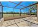 Large screened patio offering an outdoor living space with a view of the home's landscape at 1034 Mandarin Dr, Holiday, FL 34691