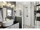 Beautiful bathroom featuring a white vanity, large mirror, and glass-enclosed shower with mosaic tile floor at 1050 22Nd N Ave, St Petersburg, FL 33704