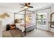 Bedroom with an ornate black canopy bed with side tables, decor and lots of light at 1050 22Nd N Ave, St Petersburg, FL 33704