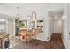 Sunlit dining area with a wooden table, unique mirrors, and view to the kitchen at 1050 22Nd N Ave, St Petersburg, FL 33704