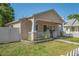 A quaint single-story home with a covered front porch and white picket fence at 1050 22Nd N Ave, St Petersburg, FL 33704