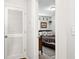 Hallway with a louvered door leading to bedroom with a bed with gray bedding at 1050 22Nd N Ave, St Petersburg, FL 33704