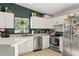 Bright kitchen with white cabinetry, stainless steel appliances, and stylish tile flooring at 1050 22Nd N Ave, St Petersburg, FL 33704