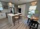 Cozy dining area with a modern table, chairs, stylish pendant lighting, and adjacent kitchen with stainless appliances at 110 Kenwood Ave, Clearwater, FL 33755
