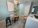 An eat-in kitchen featuring a wood table, modern stools, decorative chandelier, and stylish accents at 110 Kenwood Ave, Clearwater, FL 33755