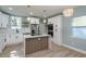 Bright kitchen featuring white cabinets, stainless steel appliances, and a stylish island with modern pendant lighting at 110 Kenwood Ave, Clearwater, FL 33755