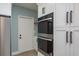 A modern kitchen with stainless steel appliances and white cabinets provides a sleek and functional cooking space at 110 Kenwood Ave, Clearwater, FL 33755