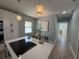 Open-concept kitchen with modern lighting, a dining area, and stylish finishes perfect for entertaining and everyday living at 110 Kenwood Ave, Clearwater, FL 33755
