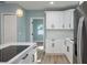 An open-concept kitchen with an island, stainless steel appliances, and modern white cabinets at 110 Kenwood Ave, Clearwater, FL 33755
