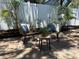 Outdoor patio featuring comfortable seating, stylish pillows, and lush greenery, perfect for relaxing and entertaining at 110 Kenwood Ave, Clearwater, FL 33755