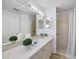 Well-maintained bathroom with a large mirror, shower, and neutral color scheme at 11218 Sun Tree Rd, Hudson, FL 34667