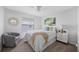 Inviting bedroom features a cozy chair, a nightstand with a lamp, and carpeted floors for ultimate relaxation at 11218 Sun Tree Rd, Hudson, FL 34667