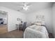 Bright bedroom with white walls, ceiling fan, carpeted floors, and a cozy workspace for comfort and productivity at 11218 Sun Tree Rd, Hudson, FL 34667