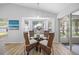 Cozy breakfast nook featuring a glass table, wicker chairs, and a bay window at 11218 Sun Tree Rd, Hudson, FL 34667