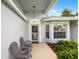 Inviting front porch with seating area and well-maintained landscaping, creating a welcoming entrance at 11218 Sun Tree Rd, Hudson, FL 34667