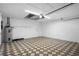 Spacious garage with patterned flooring, water heater, and ample room for parking and storage at 11218 Sun Tree Rd, Hudson, FL 34667